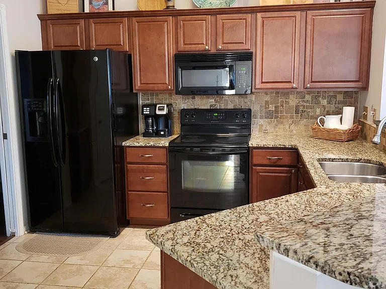 Kitchen with all cookware, bakeware, dinnerware and glassware needed for your stay