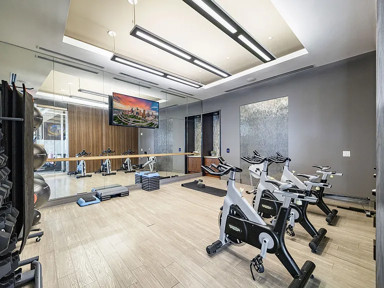Fitness studio featuring free weights, spin bikes, and ballet barre