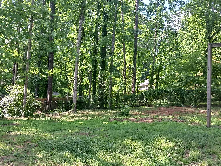 Backside of yard w swingset to relax.
