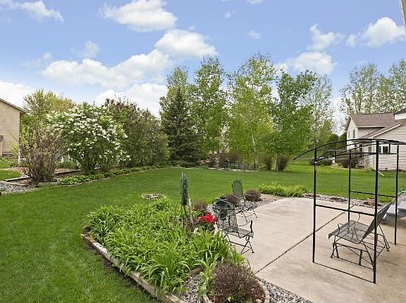 Enjoy spending time outdoors with a large backyard patio, spacious yard, and beautiful landscaping