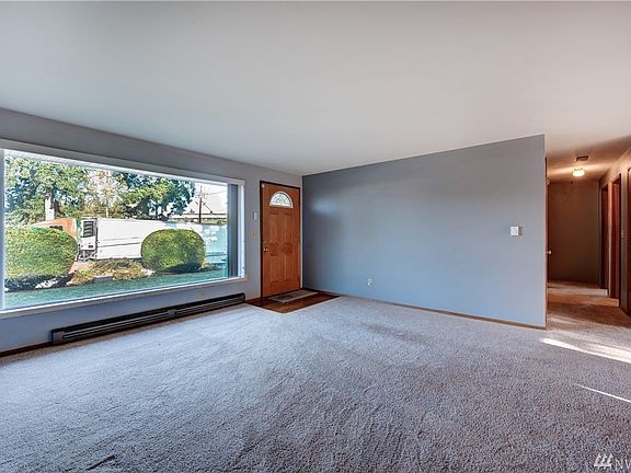 As you enter the home, you are welcomed by a light and bright living room. A large picture window allows tons of natural light to flood the room. 