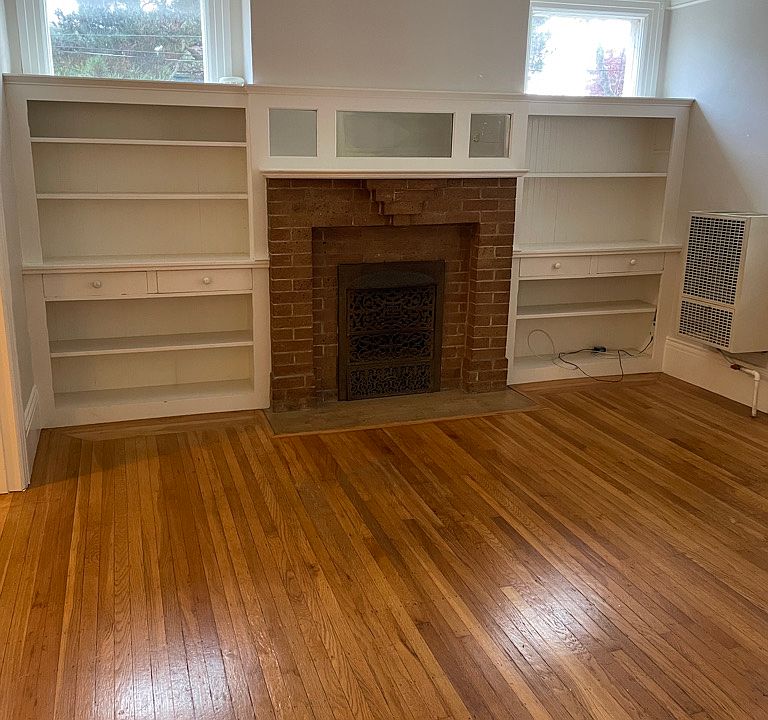 living room with decorative fireplace and built in shelving