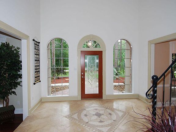  Stunning 2-story foyer with travertine tile and mosiac tile medallion