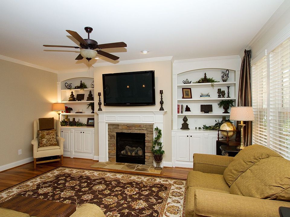 This family rm. has warmth thanks to the fireplace's stone surround & hearth.