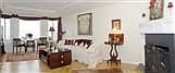 Ocean views living room w/ period molding detail & orig. woodburning fireplace