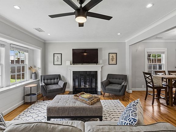 Hardwood flooring throughout, recessed lighting, and a ceiling fan