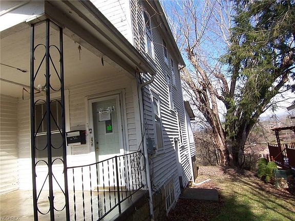 R.side with front porch-front entry,   plus outside basement entry.