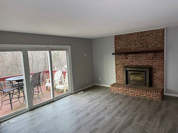 Family Room with Fireplace and Triple Slider to Rear Deck