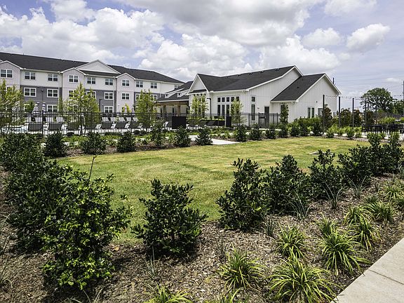 Lush landscaped courtyards with lounge areas.