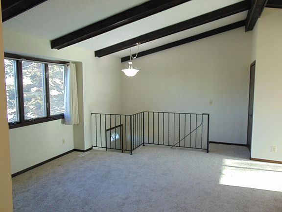 Spacious living room, new curtains and carpeting, enjoy the vaulted ceiling. Entire house freshly painted.