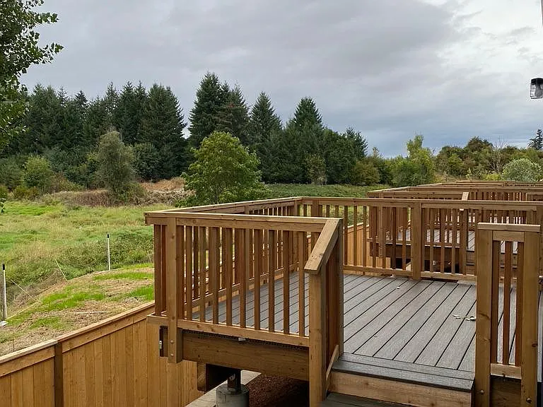 Back deck overlooking mature landscaping.