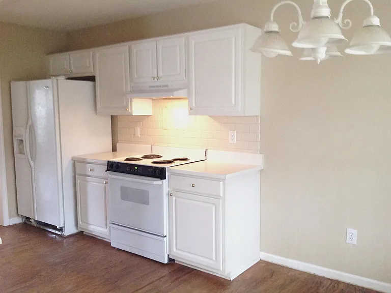 Range with full size oven, refrigerator with ice maker in door.