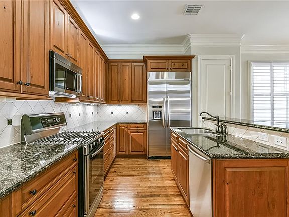 Amazing kitchen with knotty cherry cabinets and granite counters.
