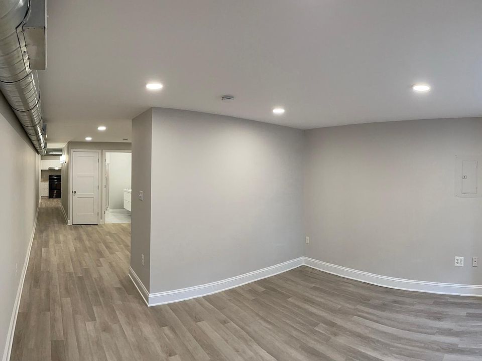 Entry looking at living room space, bathroom, and kitchen beyond.