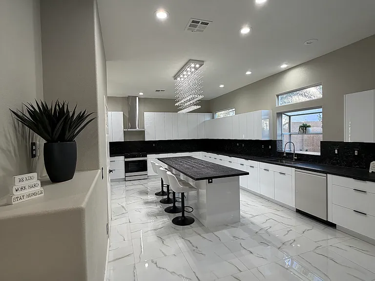 Alternate view of the contemporary kitchen with large center island and granite countertops.