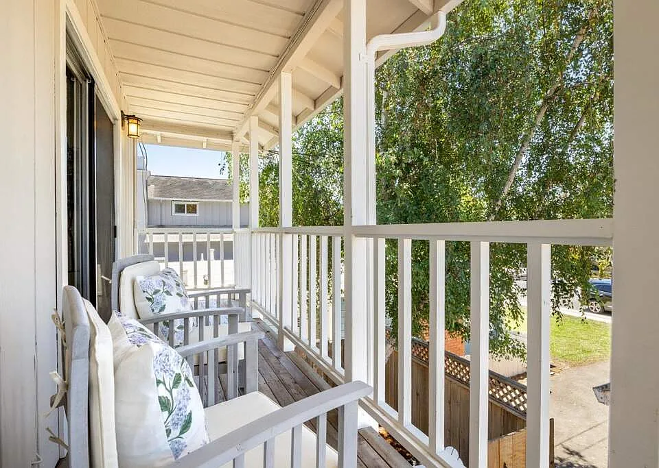 Private balcony/deck with view of sunset- off livingroom through a sliding glass door with screen