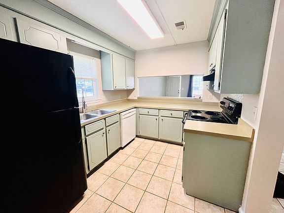 Kitchen with stove, fridge, dishwasher, garbage disposal. Laundry off the kitchen with hookups.