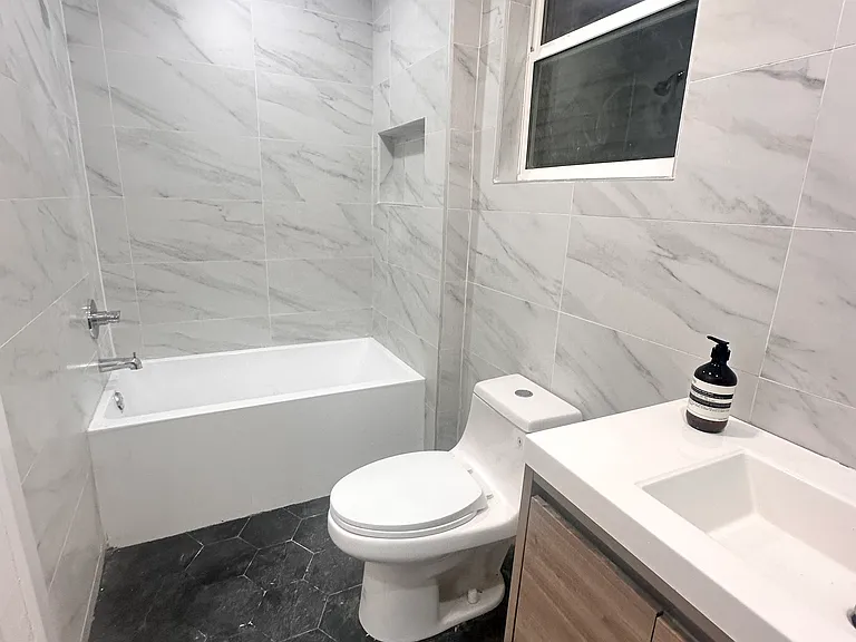 Modern designer bathroom with floor-to-ceiling Italian tile.