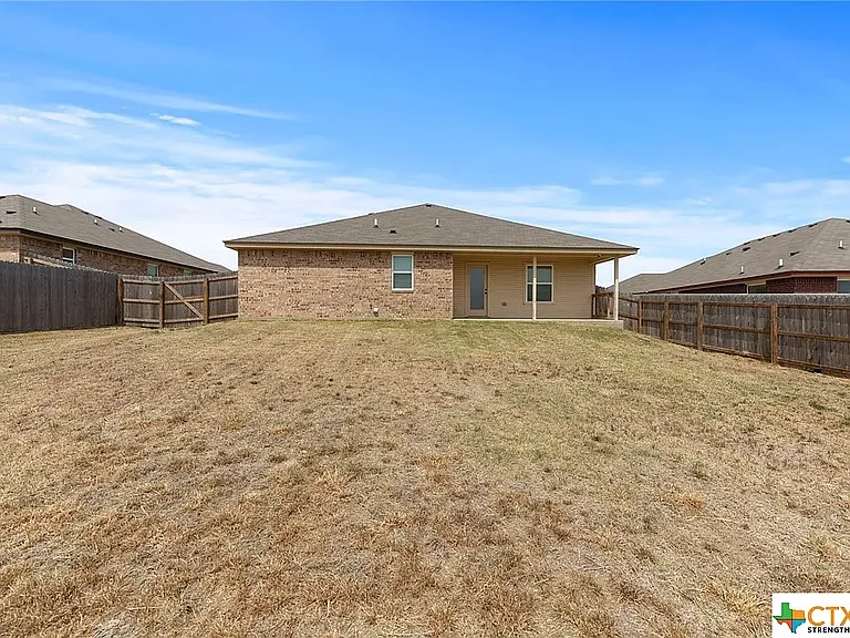 Fenced in backyard. Concrete patio was extended (patio in photo is old)