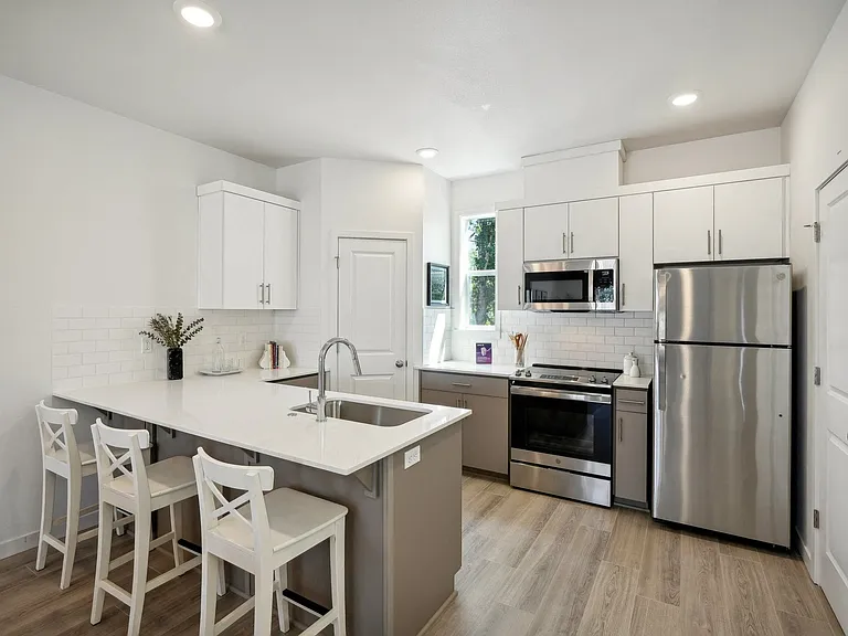 Tile backsplash, quartz counters, and abundant storage.