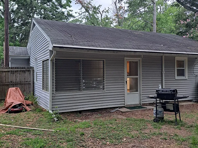 Back of house with enclosed porch