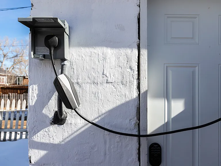nema 14-50 220 volt outlet for EV charging if needed in back alley parking spaces.