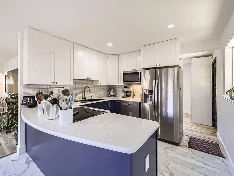 Plenty of cabinet and counter space with extra pantry to the right in the laundry room