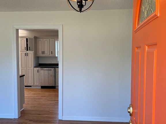 Front door opening to formal living room showing newly finished wood floors. No carpet anywhere - All beautiful oak.