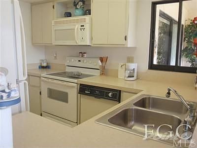 Kitchen with sink area looking at the lakes & golf course