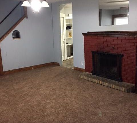 1st floor living room, wood burning fireplace, stairway to 2