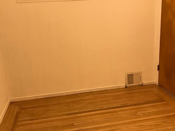 Bedroom with small window into living room