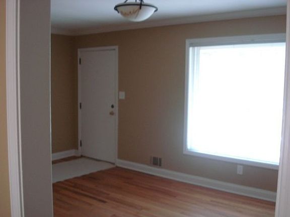 Large livingroom with huge window and hardwoods