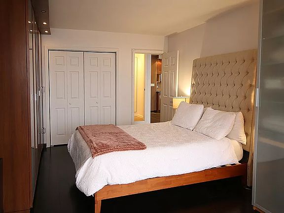 Bedroom with queen-sized bed and ample storage