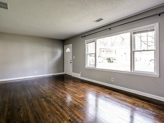 Large living room with tons of natural light and oversized w