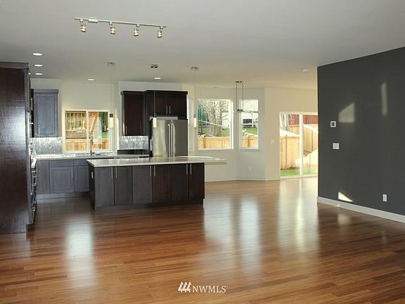 Kitchen, dining nook, and sliding doors to the fenced in back yard space from the Living Room