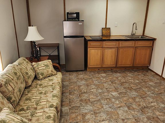 living room sleeper sofa elect fireplace kitchen pots pans knifes, forks ,plates.
