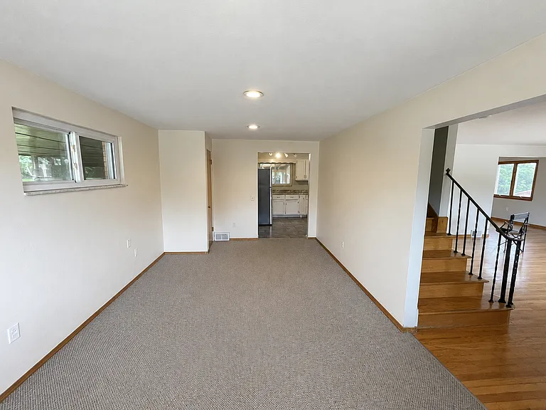 Family room connected to kitchen and entry hall and living room on right.