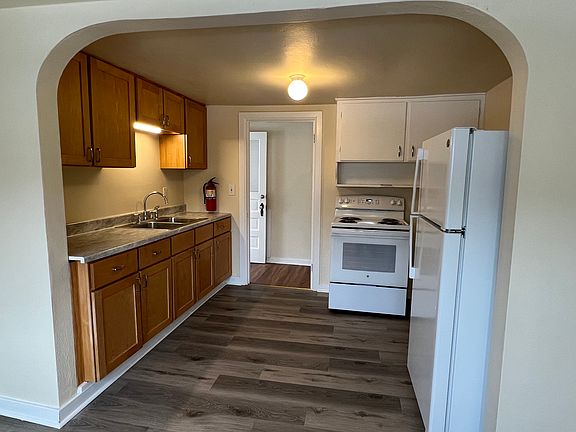 Kitchen with new stove, refrigerator and flooring