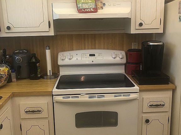 Stove, cabinets, tiled floor