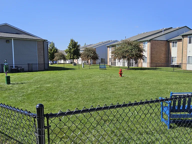 Spacious fenced dog park where pets can play, run, and enjoy the outdoors at Compass Pointe.