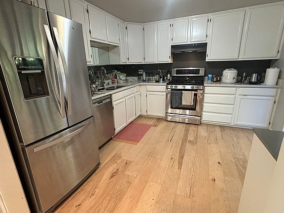 Kitchen with all Stainless steel appliances. Lovely breakfast nook overlooking a terraced garden with deck