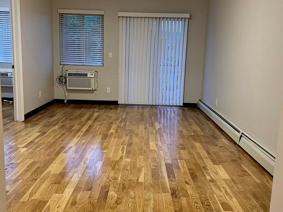 Large living room with brand-new LG 12,000 BTU A/C and remote and refinished hardwood floor.