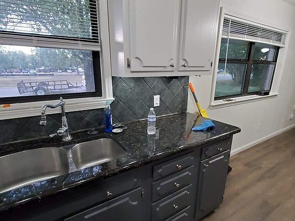 Granite countertops in the galley style kitchen.