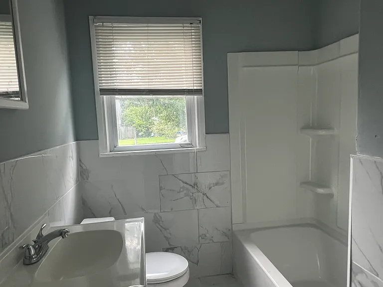 Fully renovated ceramic tiled floor, wall and new bathtub and vanilty