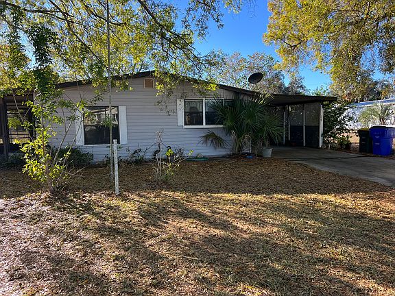 Front exterior with carport
