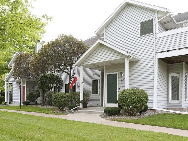 View of typical private, covered front entrance and sidewalk