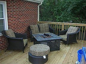 Back deck, fire pit in fenced in backyard.