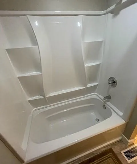 The bathroom includes a brand new shower/bath tub.
