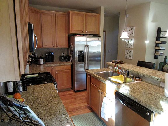 Granite tile counters with stainless appliances and a breafa