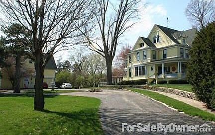 Part of the carriage house (3 car garage), circle driveway, and 3 story house.